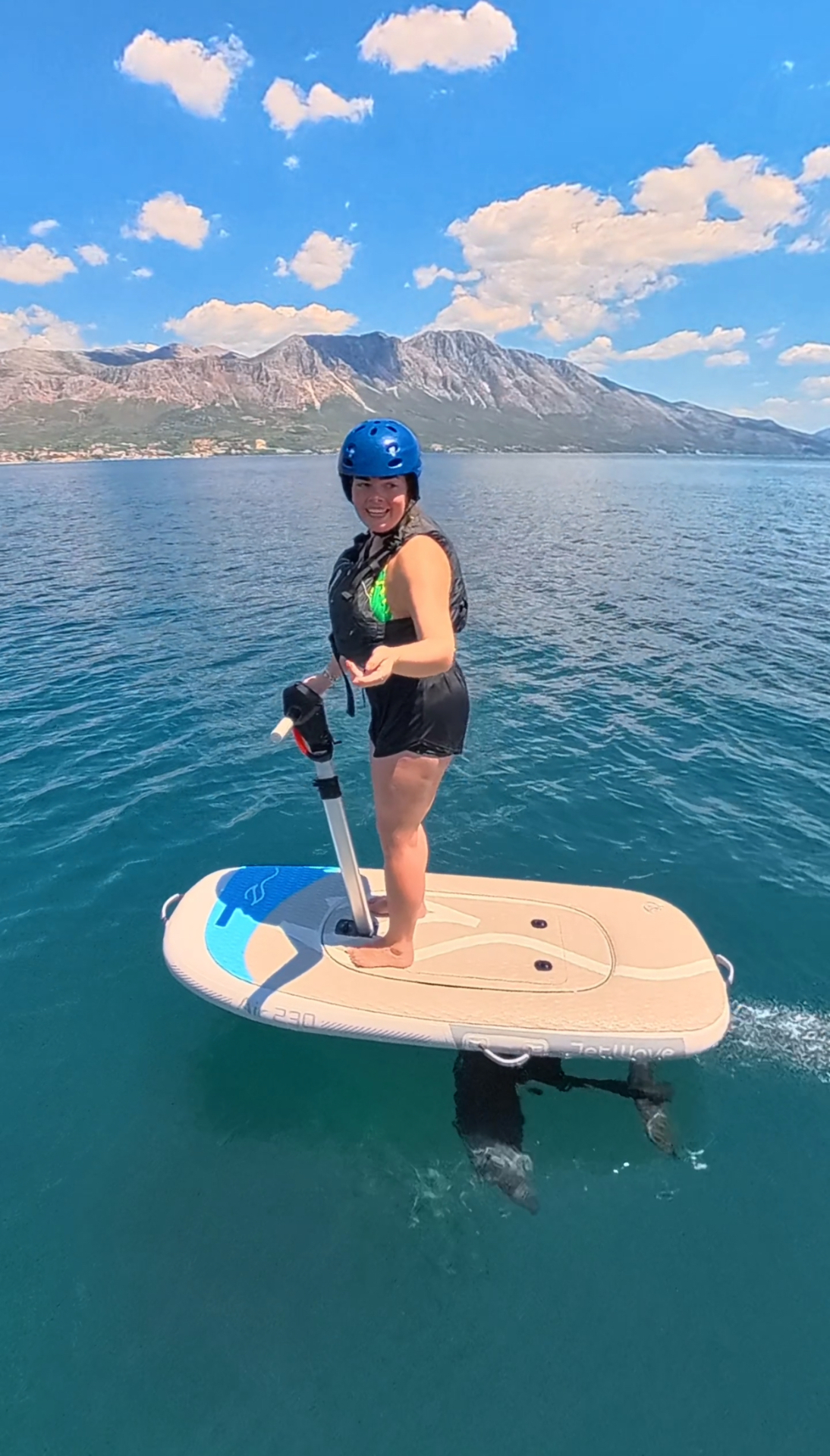 Jet-powered board rider with mountain backdrop in Paleros