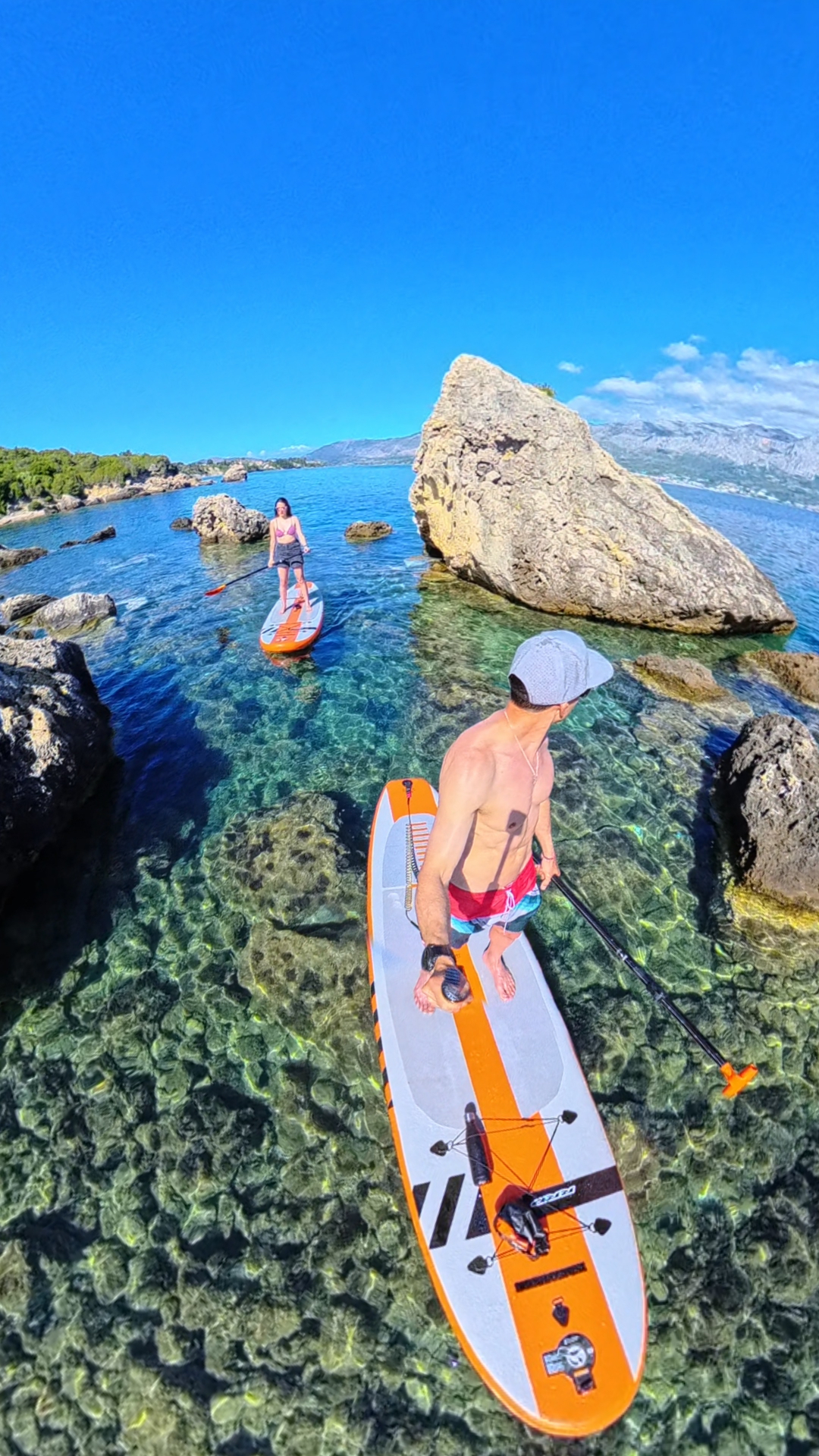 Paddleboarders exploring rocky Ionian coves