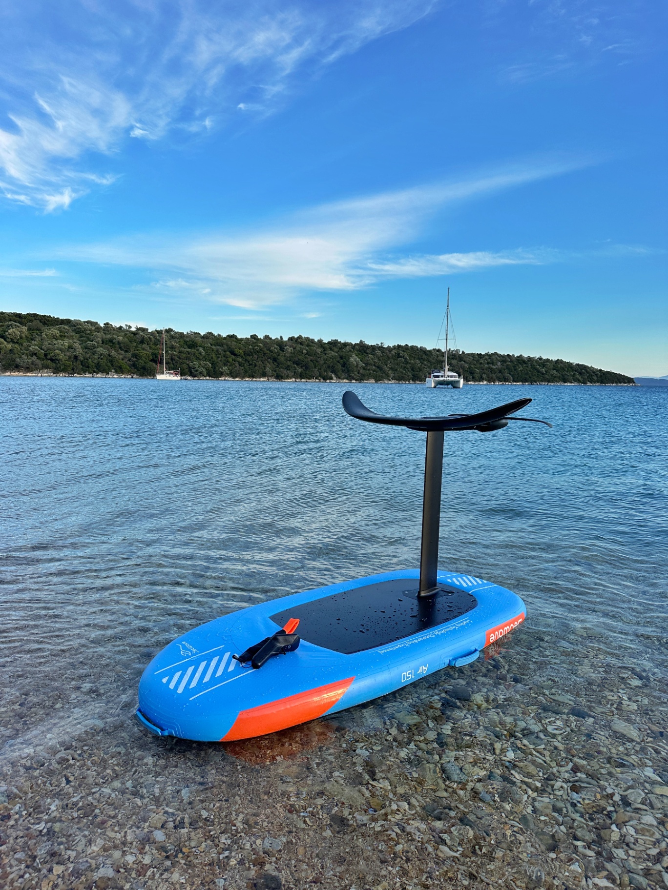 E-foil board resting on a quiet shore at golden hour